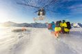 Skiers take shelter as a helicopter leaves them to explore some runs in the San Juan mountains outside Telluride.