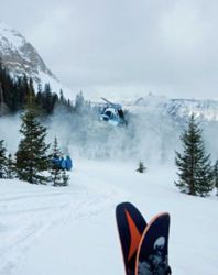 A helicopter lands to pick up some backcountry skiers in Telluride's San Juan mountain range
